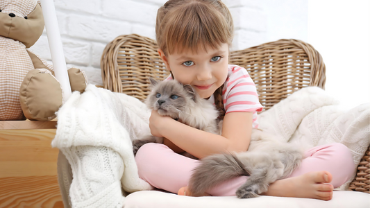 Girl embracing cat